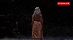 Eine Frau mit rotem Kleid im Wald