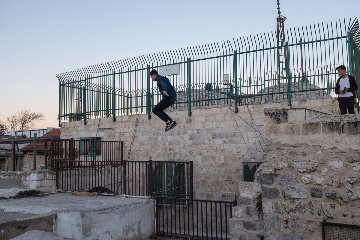 A Palestinian teenager jumps from one roof to another performing parkour. The group of athletes uses to gather and practice on Friday and Sunday afternoon.