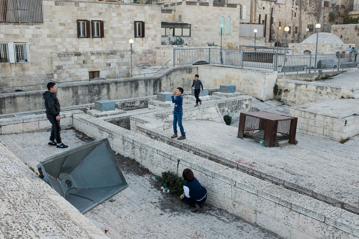 Palestinian boys play on the roof tops.