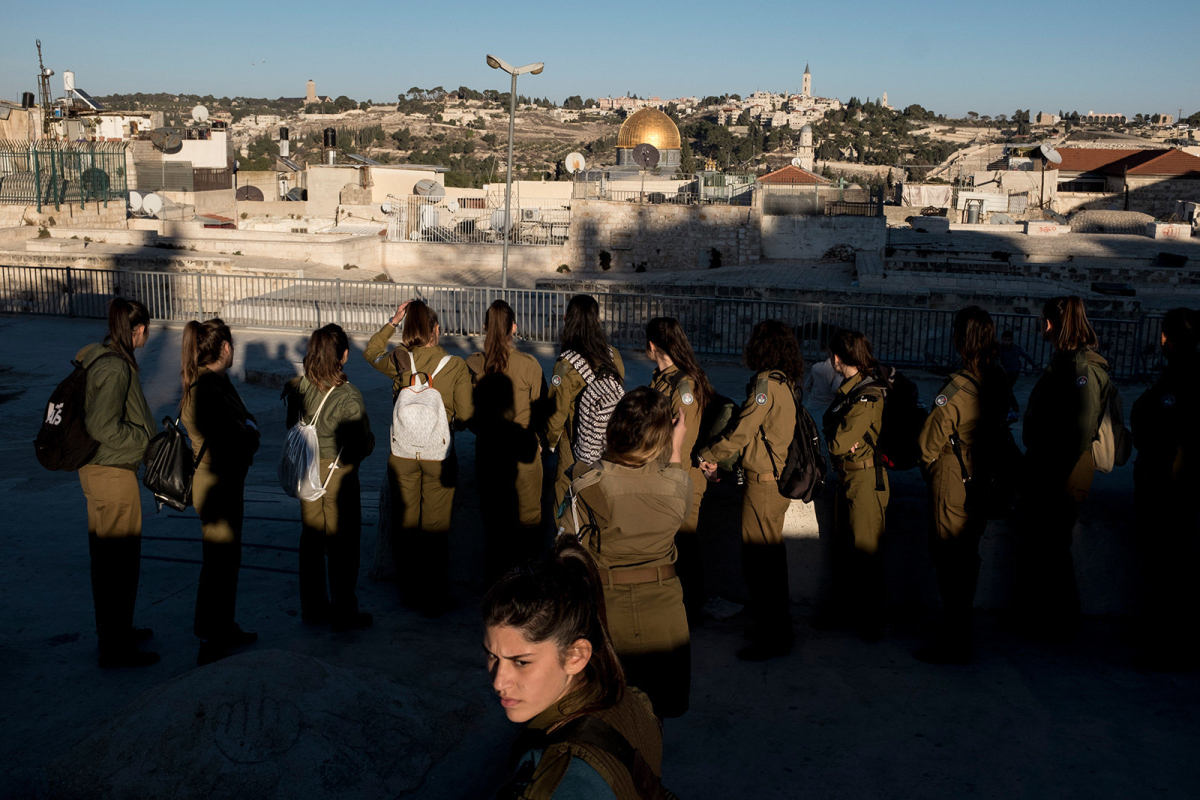 A group of Israeli female soldiers are brought on the roof tops for a class about Jerusalem Old City history